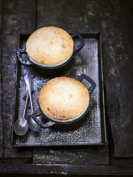 Two Souffles in dishes on a black tray