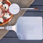 Pizza peel and pizza cutter with pizza